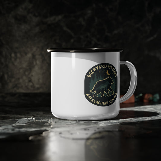 White mug with a black rim and handle, featuring a logo on a dark background