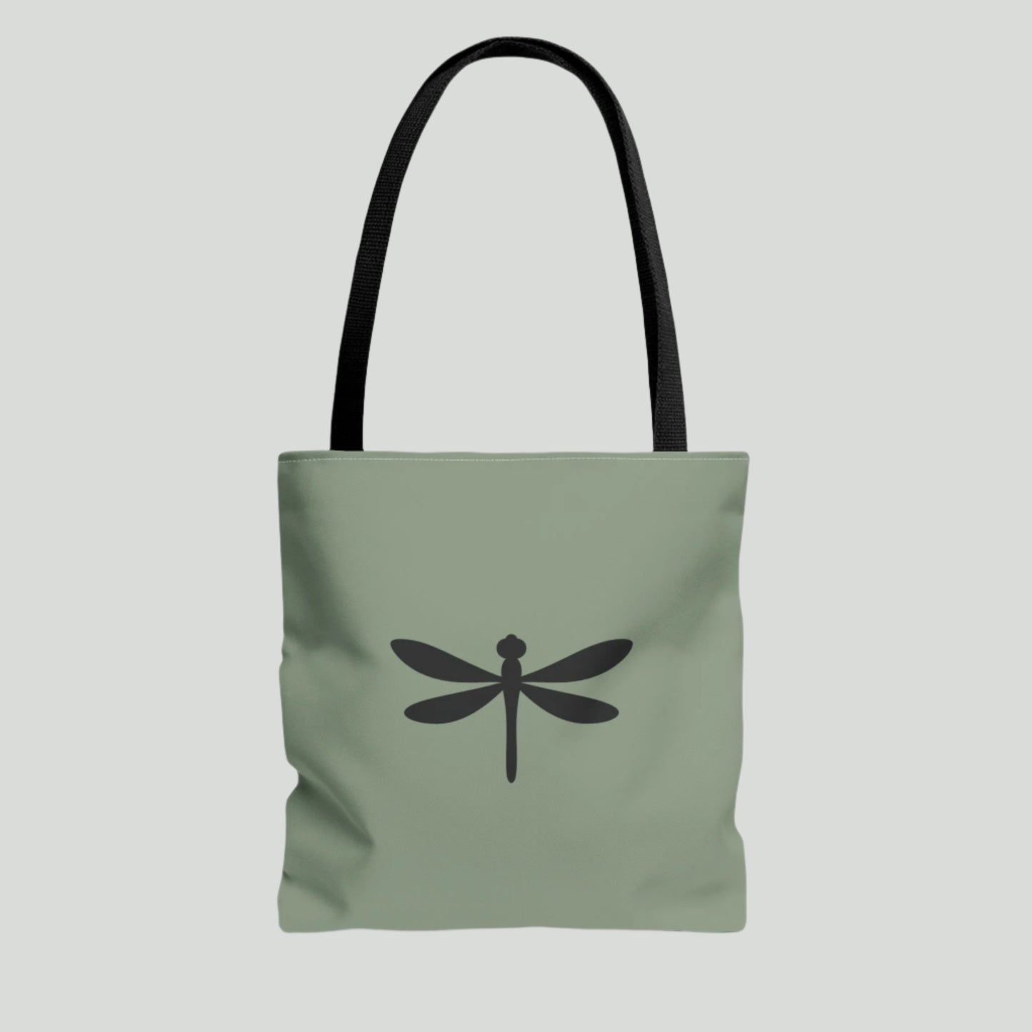Green tote bag with a black dragonfly design on a white background