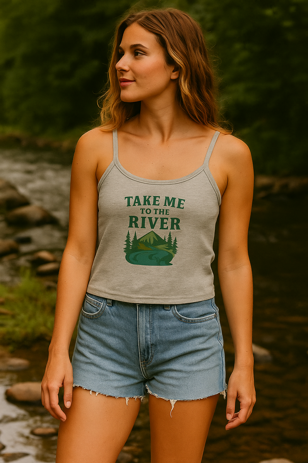 Woman wearing a tank top with a nature-themed design by a river.