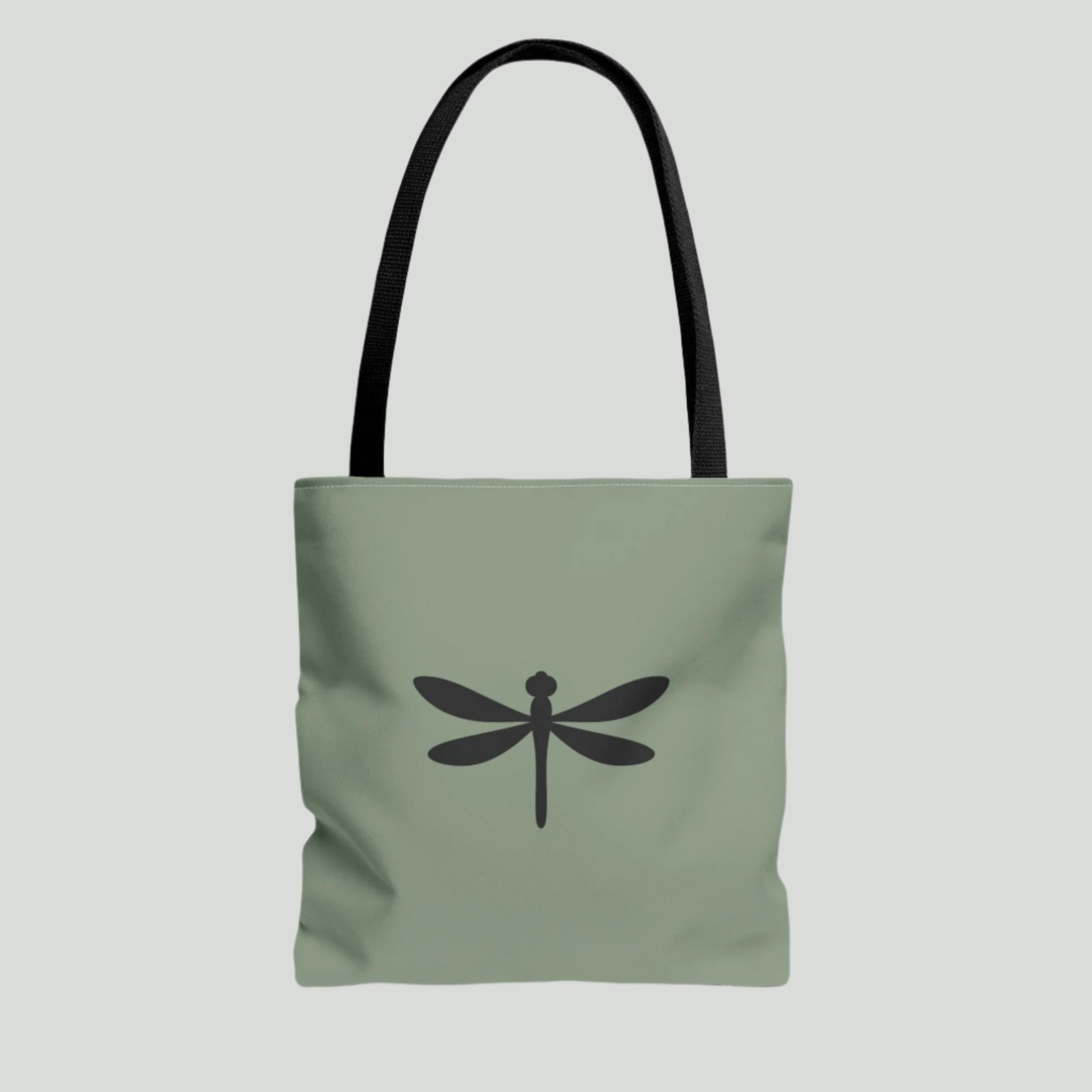 Green tote bag with a black dragonfly design on a white background