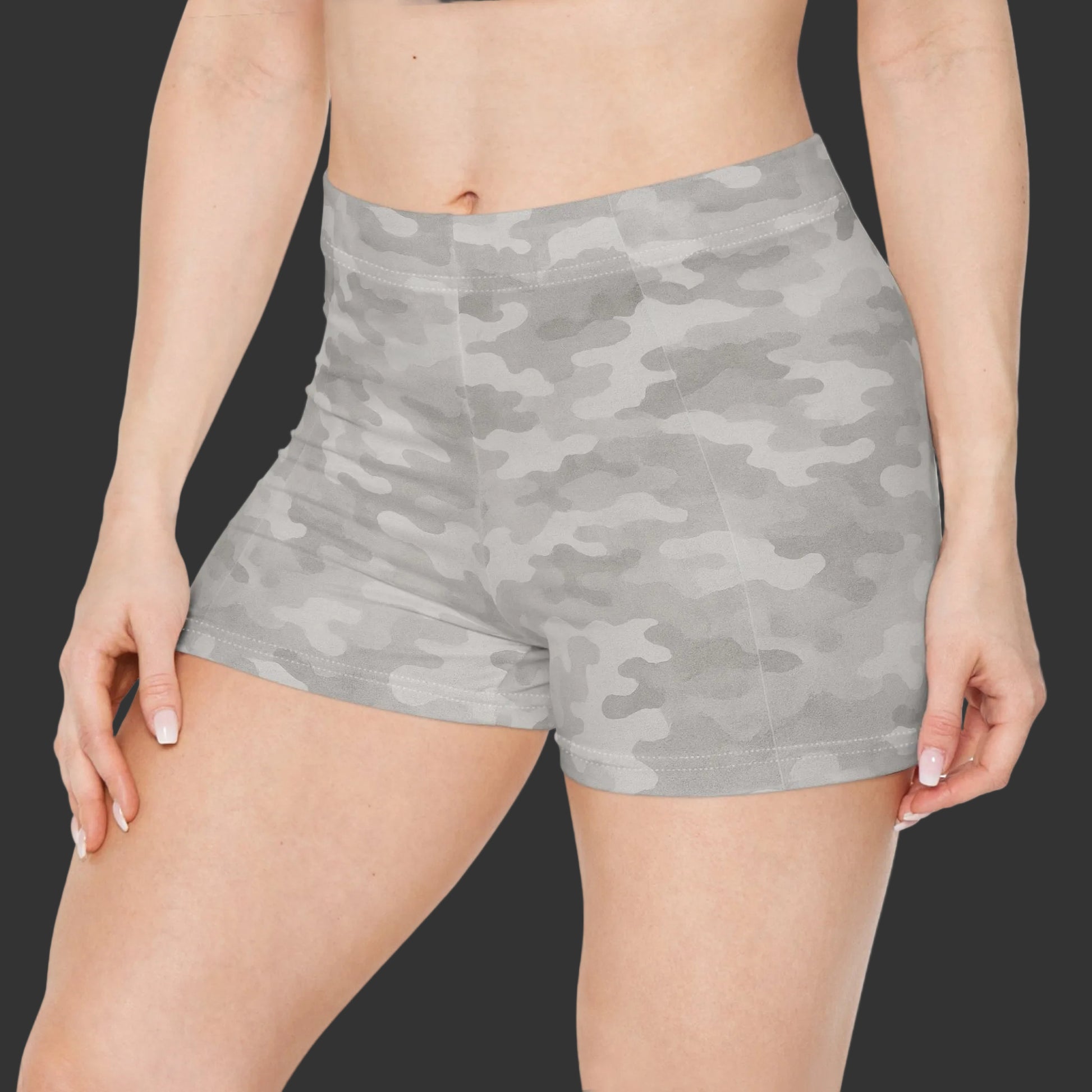 Gray camouflage shorts worn by a person on a white background