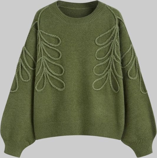 Green sweater with leaf-like patterns on a white background