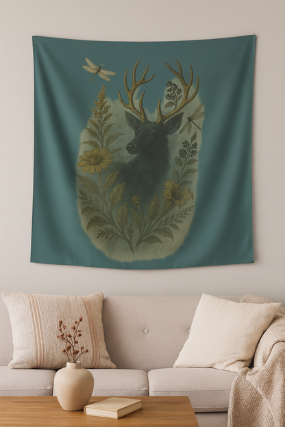 Decorative tapestry with a deer and floral design on a wall above a sofa.