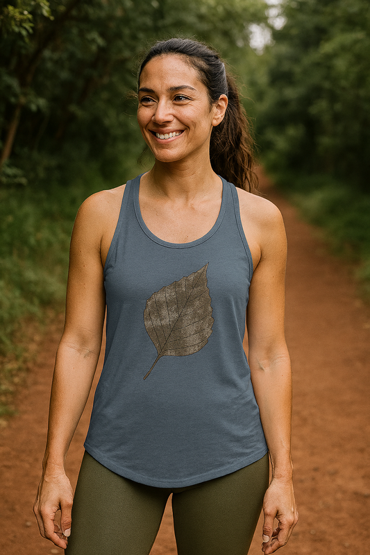 Woman wearing a blue tank top with a leaf design outdoors