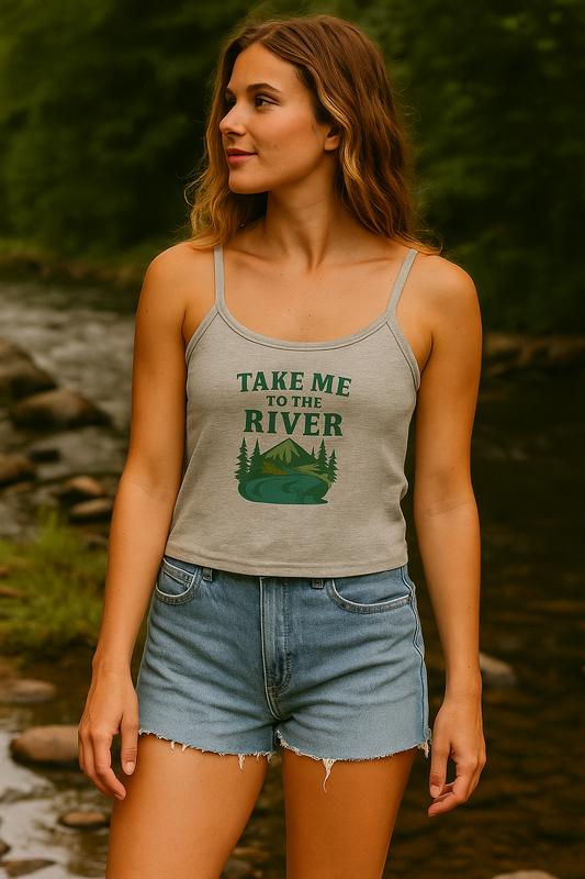 Woman wearing a tank top with a nature-themed design by a river.